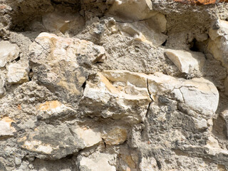 Ancient stone wall with rustic texture and weathered rock patterns