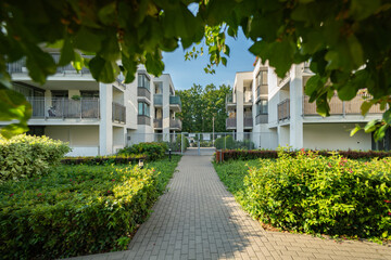 A secluded walkway inside a private residential area leads to a closed gate. The secure, gated...