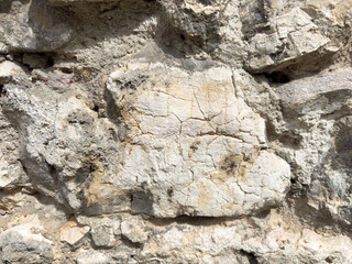 Close-up of weathered stone surface with cracks and textures