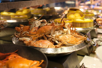 Baked assorted seafood cuisine of Mixed fish fillet, shrimps, squid, squid eggs, fish roe, mussels, clams and crabs with red sauce and herbs, cooked in the oven, hot and fresh seafood meal. High