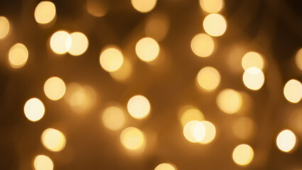 Obraz premium Blurred golden lights create a festive and warm bokeh background