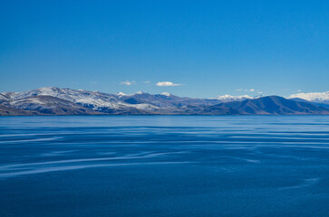 Artanish peninsula on the eastern coast of Lake Sevan and snow covered Areguni mountains...