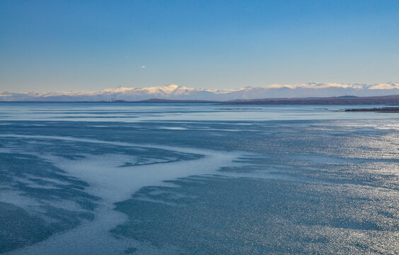 Sevan lake and snow-covered peaks of Vardenis Mountain range from Sevan peninsula (Gegharkunik Province, Armenia)