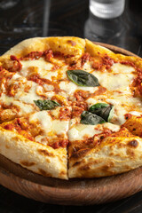 Closeup on freshly baked italian pizza margherita with basil