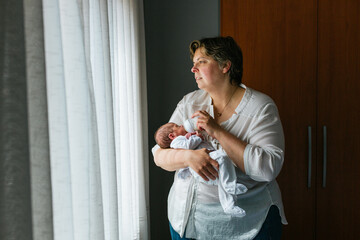 Mother feeding her one month old baby son with a bottle