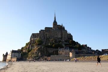 view of famous Le Mont Saint-Michel tidal island in beautiful twilight during blue hour at dusk, Normandy, France