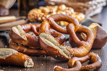 Salted bavarian pretzel on wooden table.