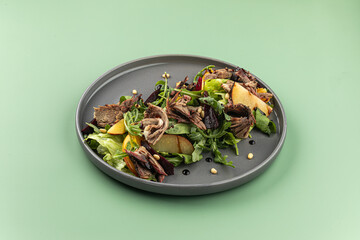 Portion of gourmet salad with beef and beets