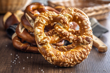 Salted bavarian pretzel on wooden table.