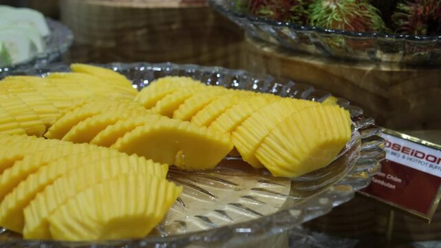 Half cutted cubes slices ripe mango on poolside background, nobody. High quality 4k footage