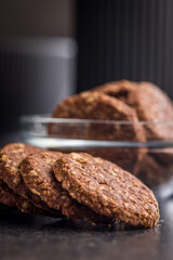 Sweet oatmeal cookies on black table.