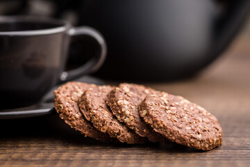 Sweet oatmeal cookies on wooden table.