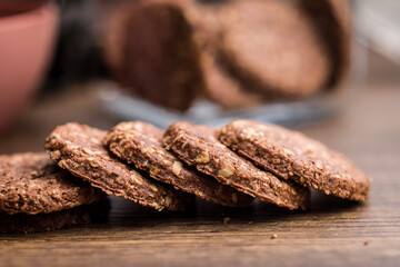 Sweet oatmeal cookies on wooden table.