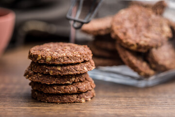 Sweet oatmeal cookies on wooden table.