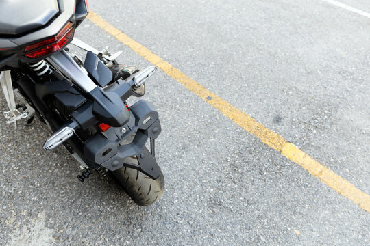 Rear Wheel and Brake System of Modern Adventure Motorcycle on Asphalt Road in Thailand..