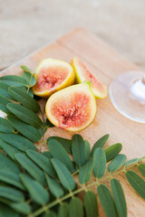 cut figs on a wooden board near the sea