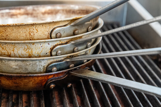 Stacked weathered chef skillets 