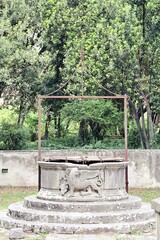 ancient well with the symbol of the Venetian Lion with wings, studies in the park in Zadar
