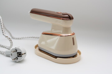 Compact clothes steamer for home use, close-up.