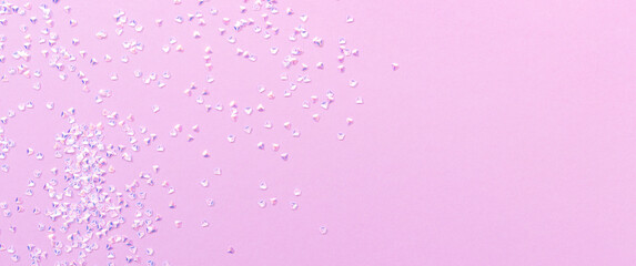 Banner with silver crystal confetti scattered on a purple background.