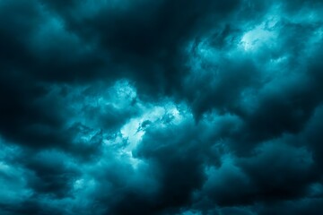 Obraz premium Dramatic blue green sky. Gloomy heavy thunderclouds. Dark teal sky background with copy space for design.