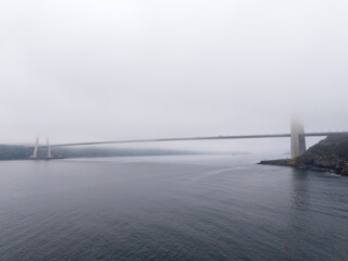 Yavuz Sultan Selim Bridge Misty Bridge over Water: A serene view of a bridge through a foggy...