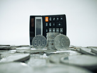 calculator and money. Stack of Indonesian coins