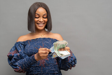 smiling young african lady counting some money