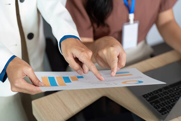 Business Collaboration. Team discussing financial reports and data analysis in a modern office.