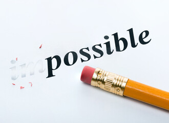 Word impossible and pencil with eraser close-up