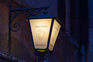 Glowing lantern with the inscription Wine on the street of Venice