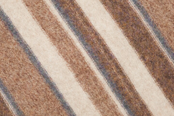Fototapeta premium Soft Knitted Woolen Detailed Texture. Natural Fabric Closeup Knit Pattern. Striped Knitwear, Warm Cashmere Surface. Rotation, Macro. Cozy Textile Background. Clothes Production. Melange Yarn. 4K Shot