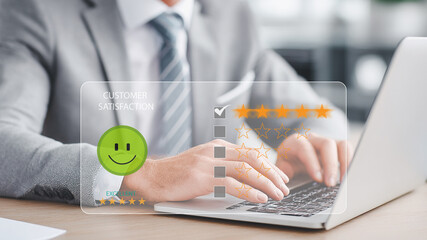 Businessman using laptop giving five-star review customer service satisfaction.