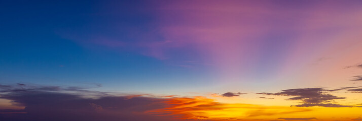 beautiful colourful sunset on Kuta Beach on the island of Bali blue purple orange skies with turquoise blue waters and silhouette of people on the sandy beach the land of gods Bali Island Indonesia  