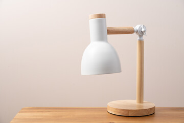 White table lamp in scandinavian style on work desk. Education, study concept background with copy space