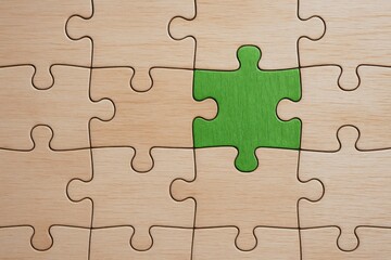 A strategic decision is symbolized by a green puzzle piece fitting into a wooden board representing business growth and effective problem-solving