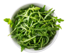 A high-angle, close-up shot reveals a white bowl brimming with fresh, vibrant green arugula leaves