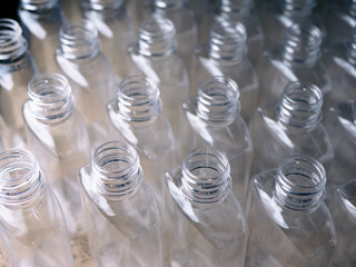 Close up Row of plastic drink water bottles for filling process.