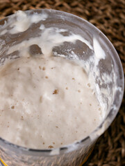 Bubbly sourdough starter in glass jar. Active yeast for bread making