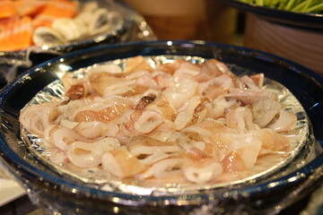 pieces of raw squid, close-up, on a plate. Sliced raw squid