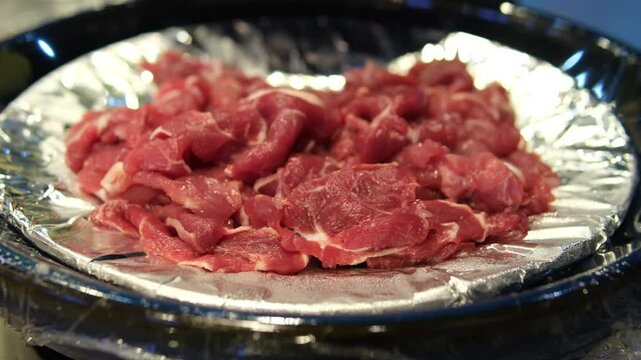 Raw pieces of beef top view, rotation. Prepare beef for cooking