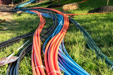Telecommunication cables are laid out on the grass in front of the installation for installation...