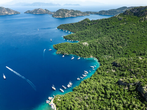 Sailing boats navigating the turquoise waters of Sarsala Bay in Dalaman, Turkey