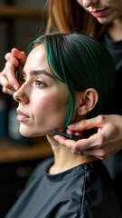 A stylist skillfully trims a woman's green hair in a modern salon, showcasing precision and attention to detail
