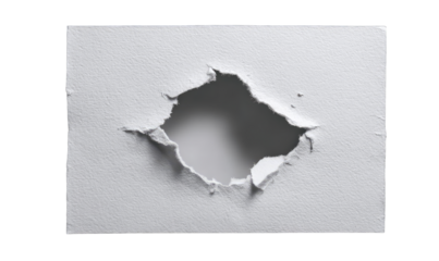 A perfectly-centered hole punched through a flat white surface, showing a smooth inner edge.  Ripped edges radiate outwards from the hole