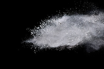 White powder or flour explosion isolated on black background.