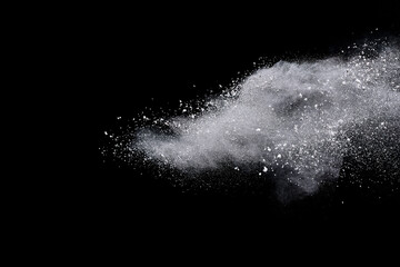 White powder or flour explosion isolated on black background.
