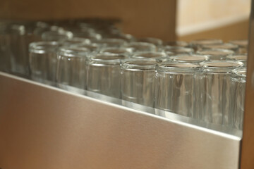 Many clean glasses on stand in school canteen