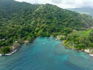 A wild, natural, and unknown beach in the middle of the jungle and mountains in the Caribbean of Colombia in Bahía Aguacate, Capurgana, Choco