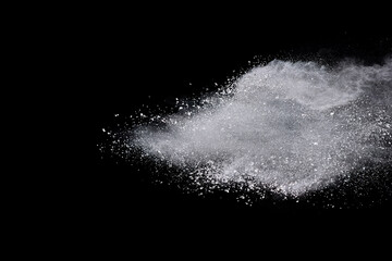 White powder or flour explosion isolated on black background.